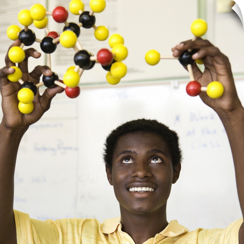 African teenage boy viewing molecule model
