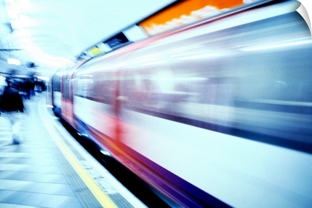 Train moving at high speed past a subway station