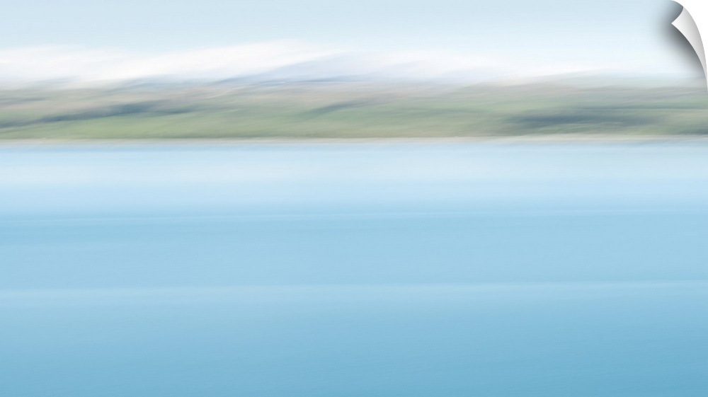 Abstract image of turquoise colors of lake Pukaki with snow-capped mountains in the distance. Image taken by intentional c...