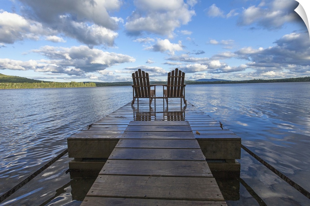 Two adirondack chair on a dock at Spencer Pond in northern Maine.