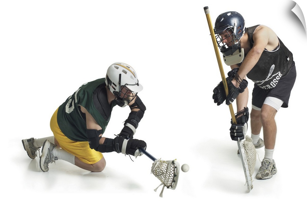 two caucasian male lacrosse players from opposing teams confront each other as one steals a pass from the other