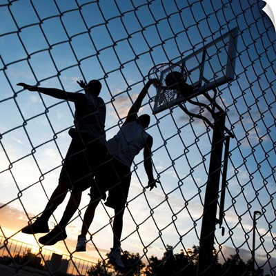 Two young men playing street basketball, low angle view