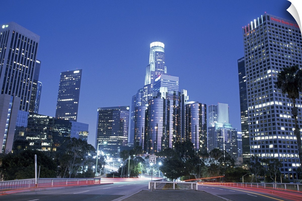 Perfect for the office, a big photograph of downtown Los Angeles lit up at night with car lights shown at a long exposure.