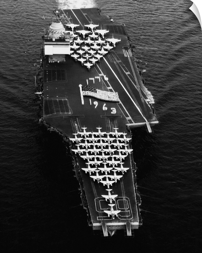 Navy crewmen form an image of the national ensign on the flight deck of the new USS Enterprise aircraft carrier.
