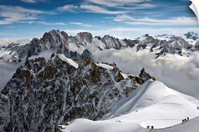 View of Mont Blanc massif in French Alps, with alpine climbers in snow, France.