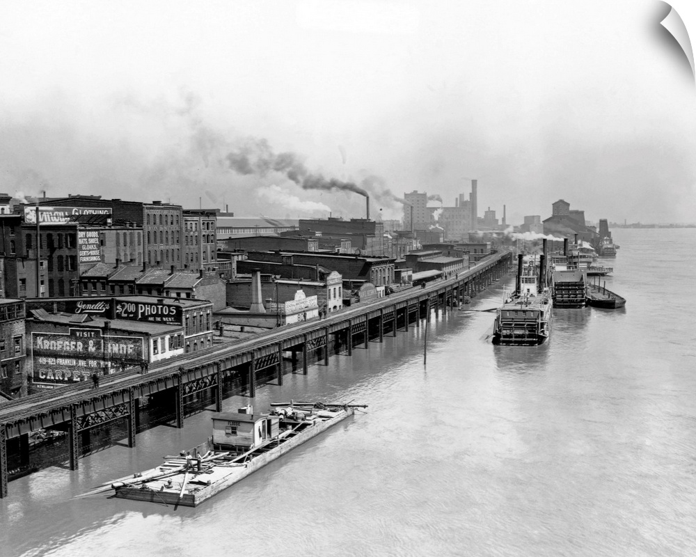 Boats move down the high water of the Mississippi River in 1892, next to the waterfront.
