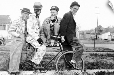 Vintage image of men as clowns on bike