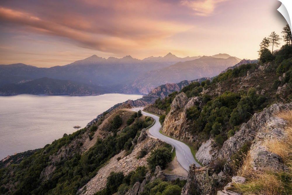 The D824 road winding its way along the coast from Capu Rossu towards Piana on the west coast of Corsica as the early morn...