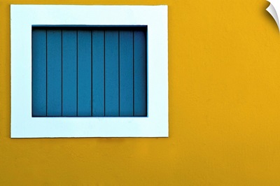 Window on yellow wall.