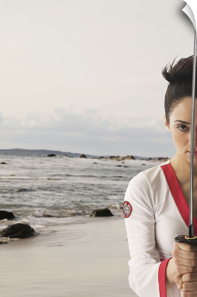 Mixed race woman performing martial arts with sword