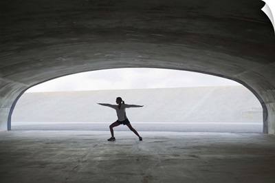 Woman stretching in tunnel