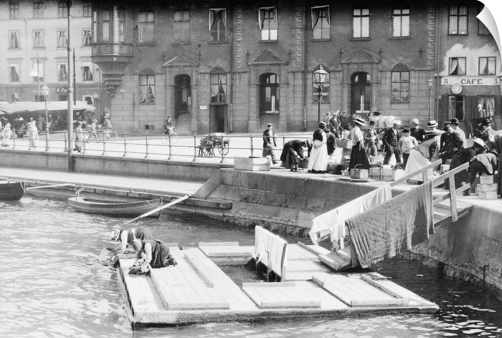 Women washing clothes in canal in Stockholm.