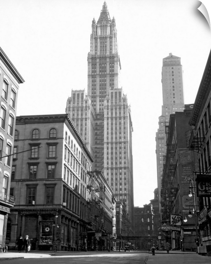 Black and white photograph of a skyscraper in New York City that towers over others surrounding it.