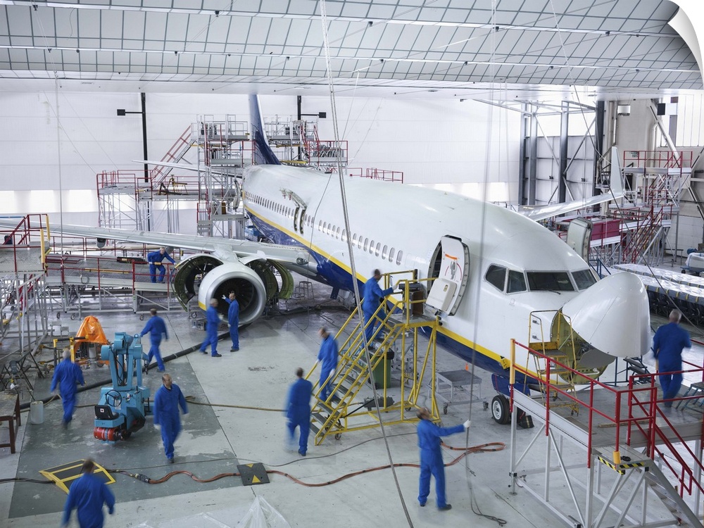 Workers in airplane hangar