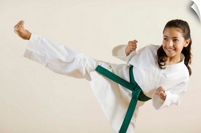Young girl doing karate kick