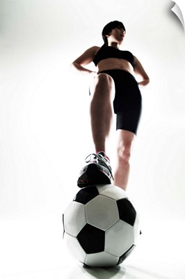 Young woman training, soccer