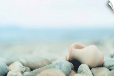 Zen composition on pebble beach, small amphora on  lies pebbles.