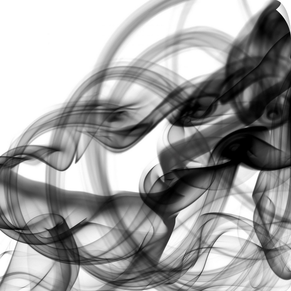 Wisps of black, billowing smoke photographed against a white background create a monotone abstract image.