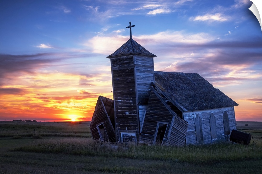Another day ends with a brilliant sunset at the old St. Johns Lutheran Church in the ghost town of Arena, North Dakota.