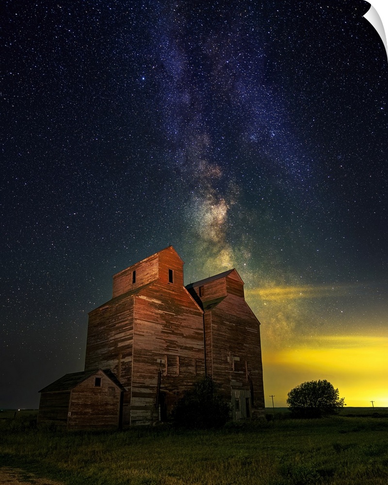 The Milky Way glows behind an old grain elevator in the ghost town of Arena, North Dakota.