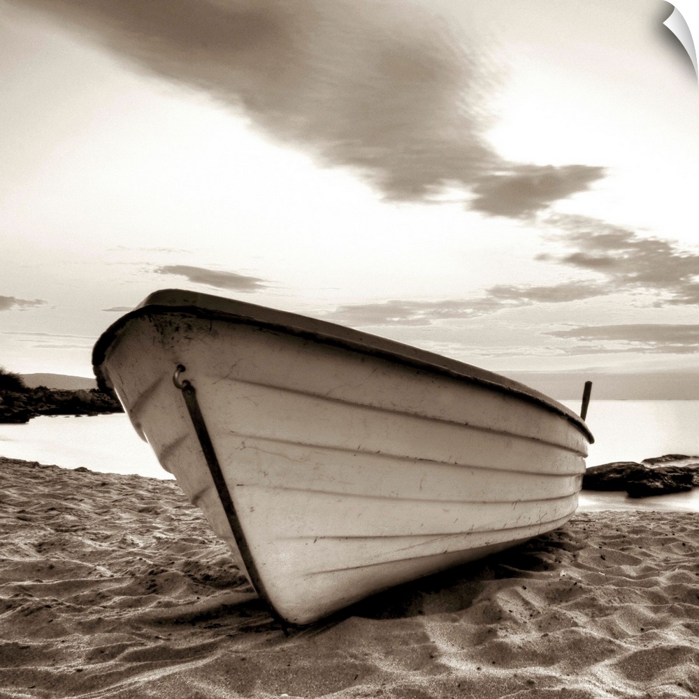 A square image of a small white boat pulled up onto a sandy beach with a dramatic line of clouds above.