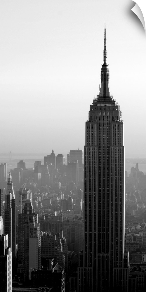 A long vertical black and white image of the Empire States Building in New York City.