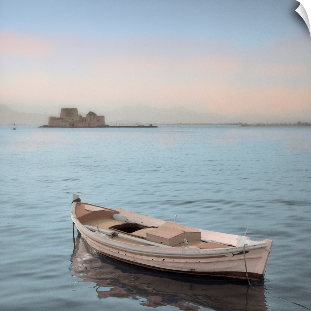 A single boat floating in the calm waters of the Mediterranean with a nearby castle in the background.