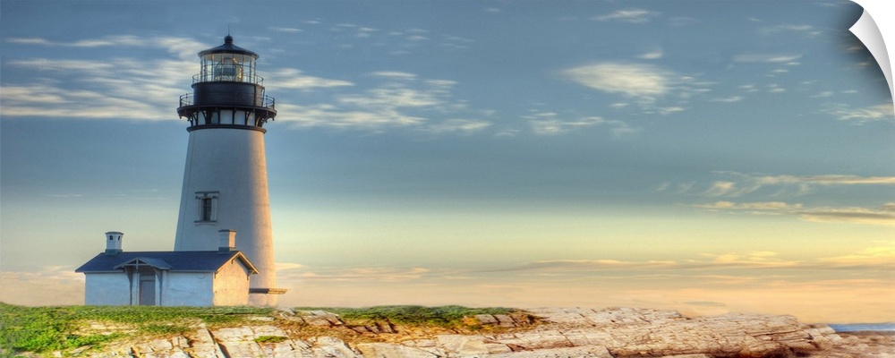 Photograph of a lighthouse against a blue sky.