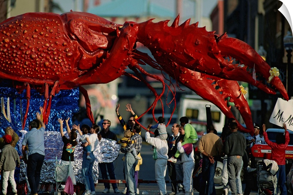 Louisianans revel beneath a giant crayfish Mardi Gras float.
