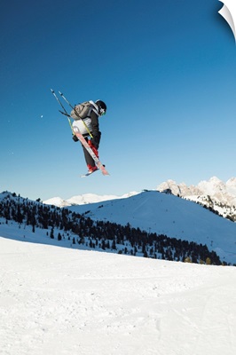 A View Of A Freestyler Flying With His Skis After A Jump In Val Gardena, Italy