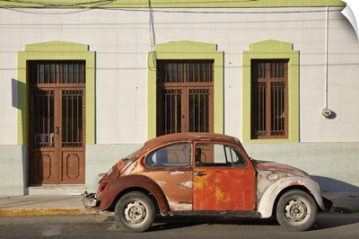A Vintage Volkswagen Beetle In Front Of A House In Merida, Yucatan, Mexico