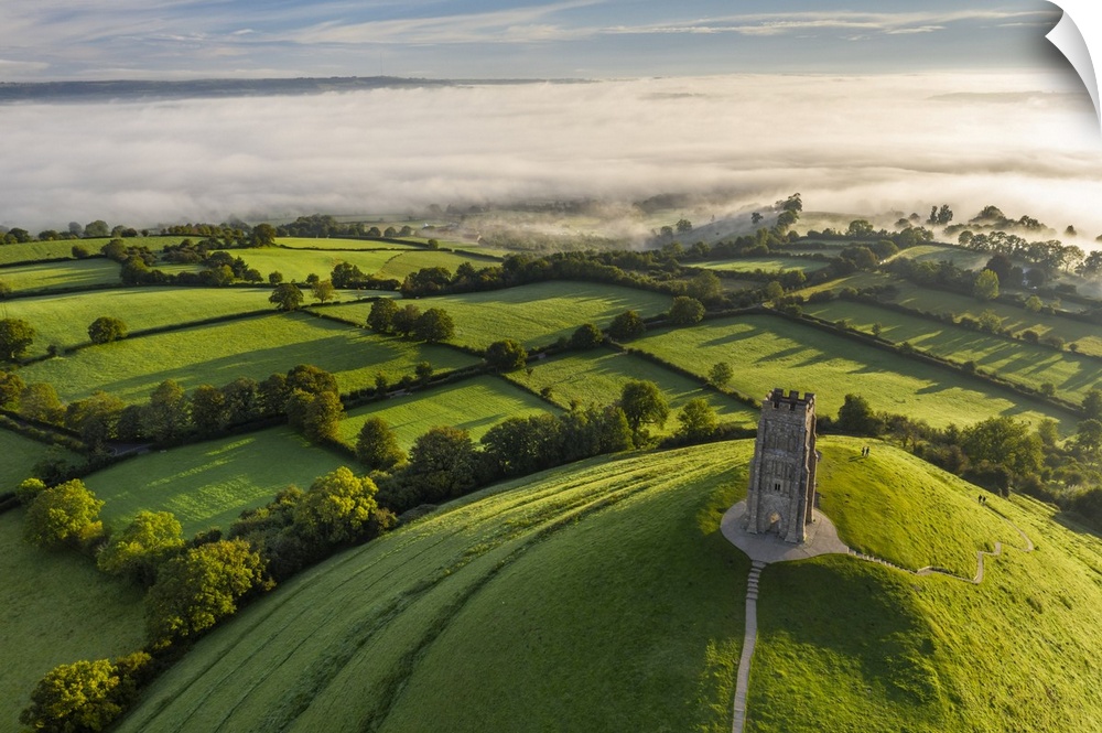 Aerial view of St. Michael's Tower on Glastonbury Tor on a misty autumn morning, Somerset, England. Autumn (September) 2020.
