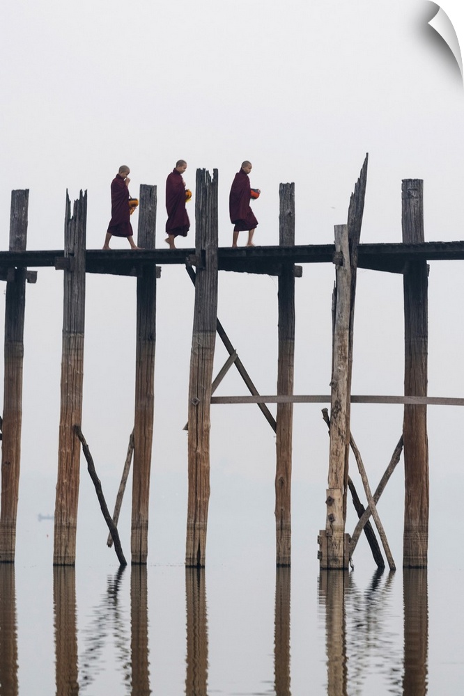 Amarapura, Mandalay region, Myanmar. Monks walking on the U Bein bridge.