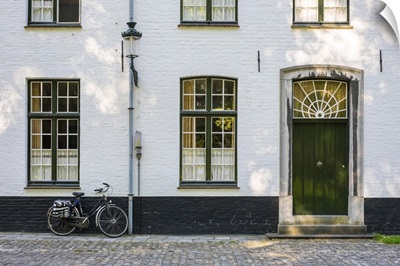 Belgium, Bruges. Bicycle next to a house in the Begijnhof (Beguinage) of Bruges