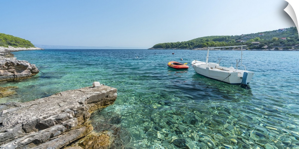 Boats at the little pier of Tankaraca cove in summer. Vela Luka, Korcula island, Dubrovnik - Neretva county, Croatia.