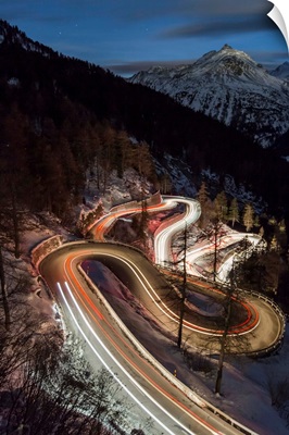 Car lights on the curvy Maloja Pass, Engadin, Graubunden, Switzerland