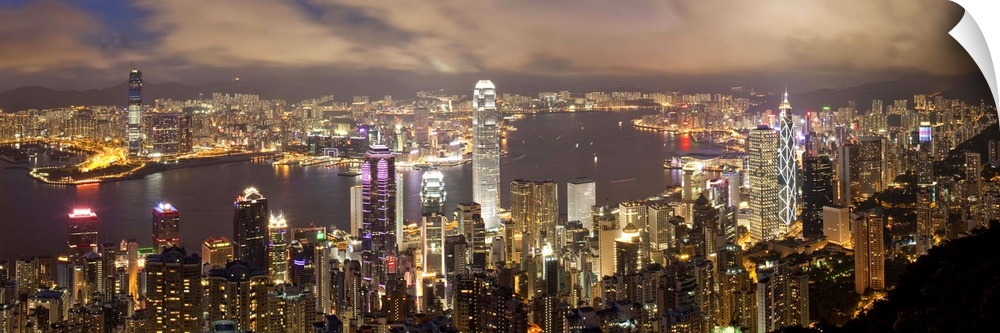 China, Hong Kong, Victoria Peak. View over Hong Kong from Victoria Peak. The illuminated skyline of Central sits below The...