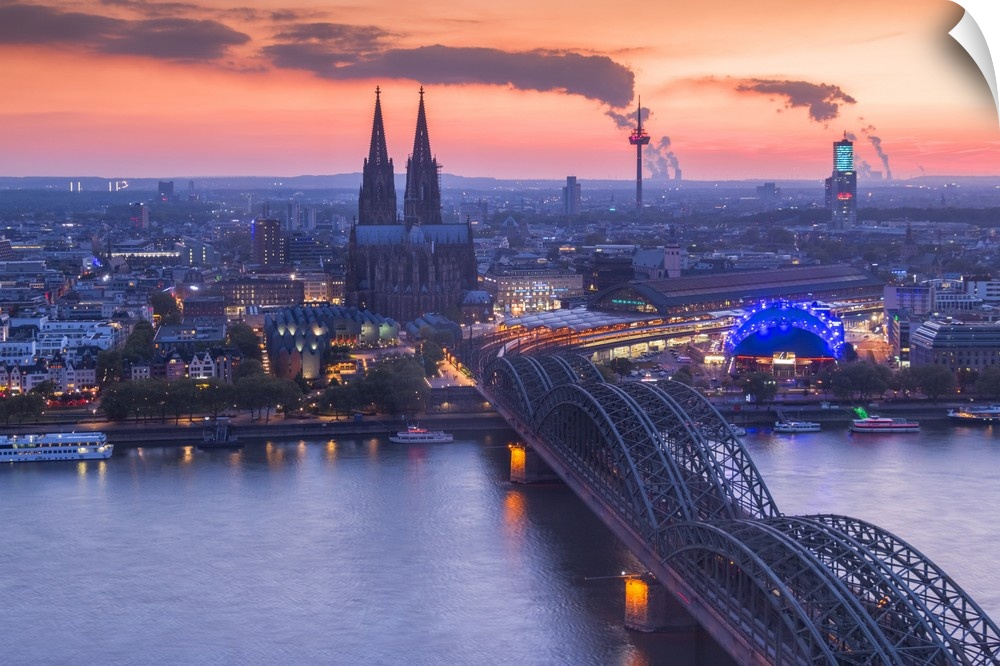 Cologne Cathedral and Hohenzoller Bridge over River Rhine in Cologne city at dusk. Cologne city (Koln), North Rhine Westph...