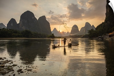 Cormorant Fisherman Throwing Net On Li River At Dawn, Xingping, Yangshuo, Guangxi, China