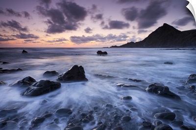 Dusk on the rocky shores of Speke's Mill Mouth in North Devon, England