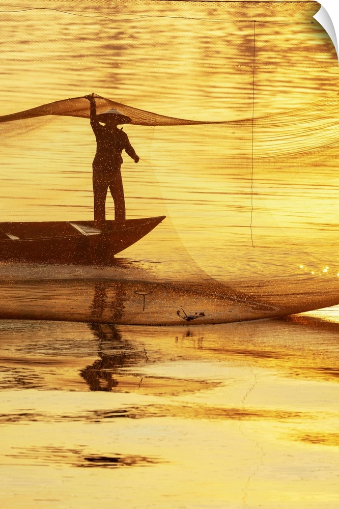 Fisherman working on the nets at sunrise, Thu Bon River, Quang Nam Province, Vietnam.