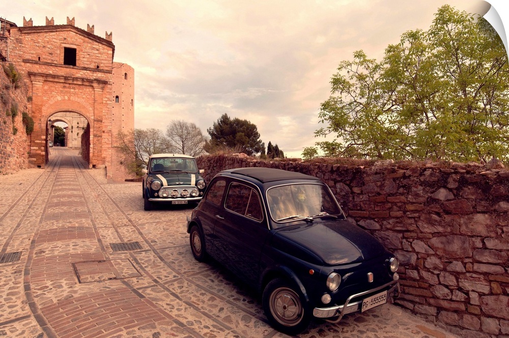 Glimpse of Spello with vintage cars in the foreground, Spello, Perugia district, Umbria, Italy.