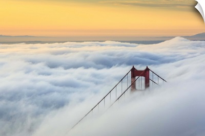 Golden Gate Bridge emerging from the morning fog at sunrise, San Francisco, California