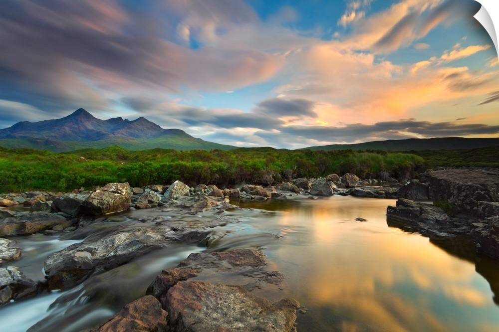 Isle of Skye, Scotland, Europe. The last sunset colors reflected in the water. In the background the peaks of the Black Cu...