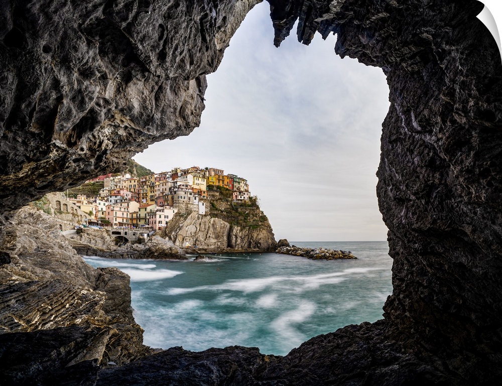 Italy, Liguria: Manarola from a cave on the shore.