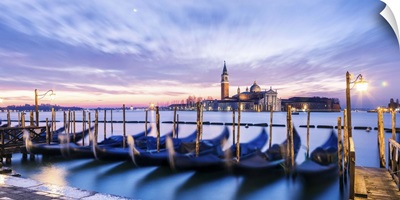 Italy, Veneto, Venice. Row of gondolas moored at sunrise on Riva degli Schiavoni