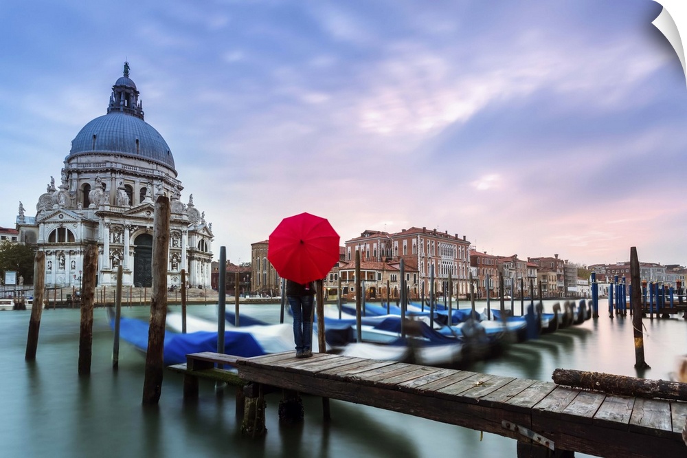 Italy, Veneto, Venice. Santa Maria della Salute church on the Grand Canal, at sunset, woman standing with red umbrella (MR)
