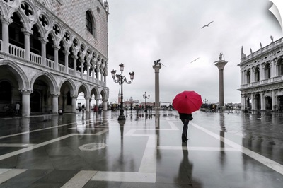 Italy, Veneto, Venice. Woman with red umbrella in front of Doges palace