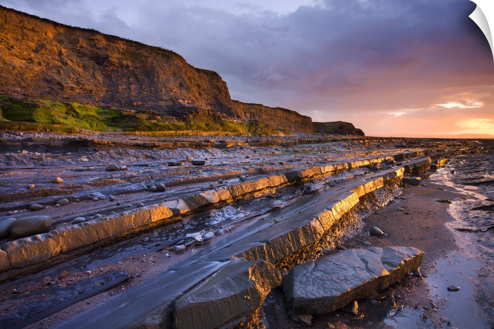 Late evening sunlight glows on the horizontal ledges of Kilve, Somerset, England. Spring (May) 2009