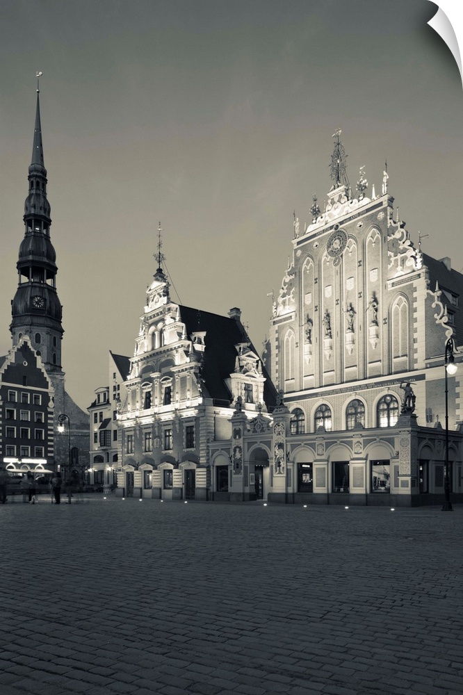 Latvia, Riga, Vecriga, Old Riga, Blackheads' House, b.1344, exterior and St. Peter's Lutheran Church, evening